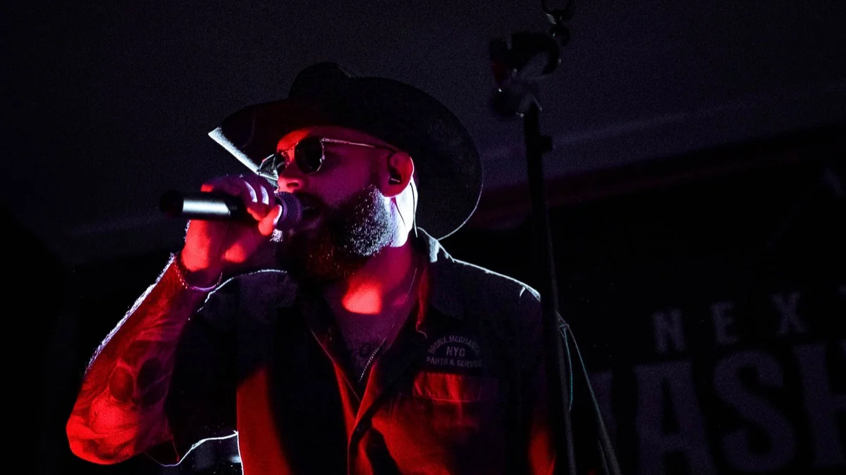 Next Stop Nashville lead singer performing in a cowboy hat
