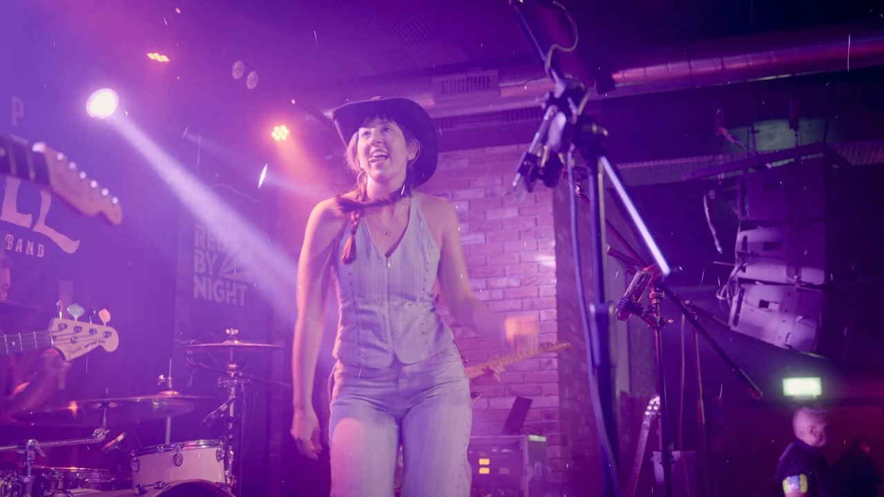 Next Stop Nashville female vocalist performing on stage