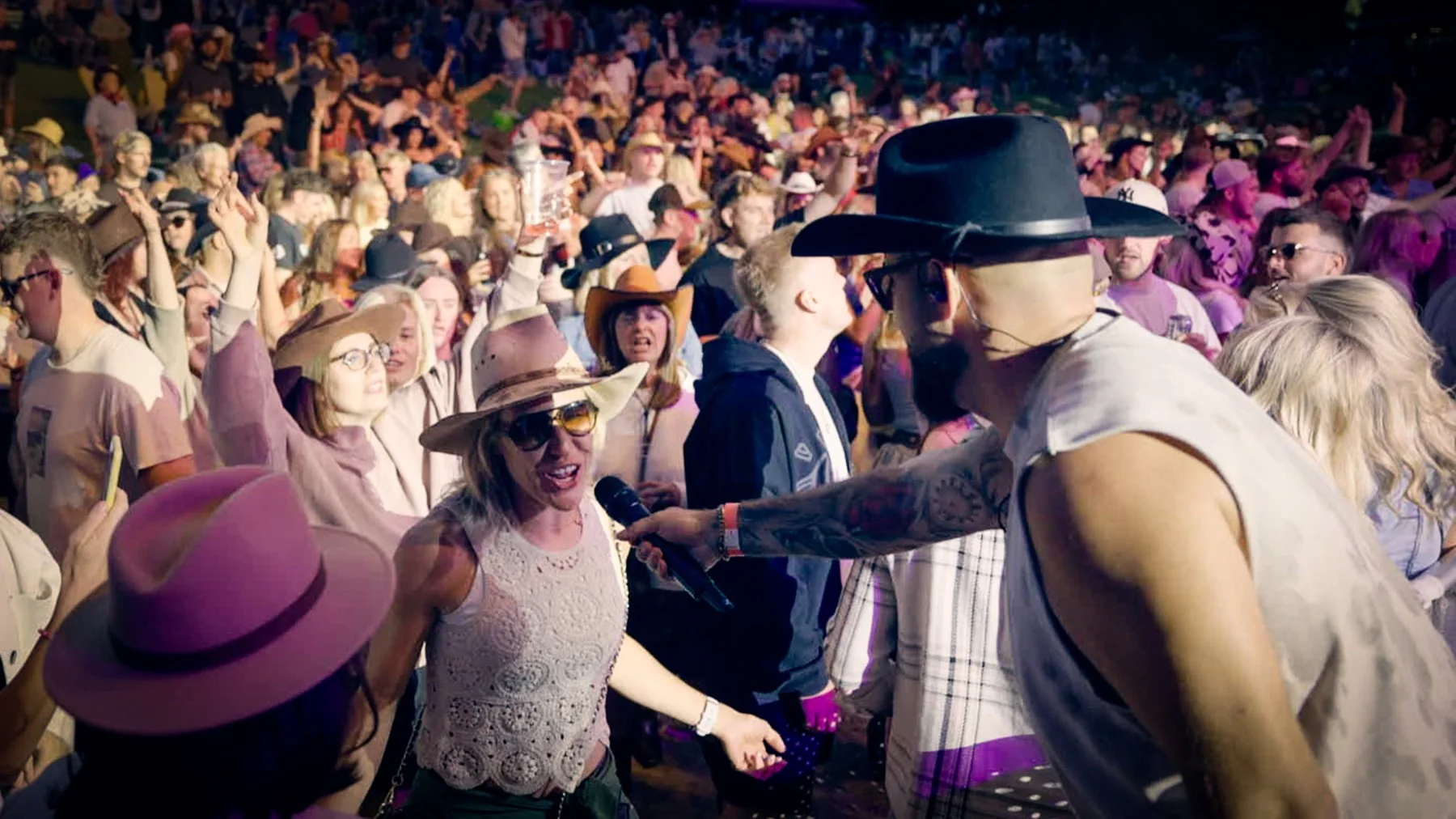 Next Stop Nashville vocalist singing in the middle of a festival crowd